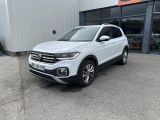 a white volkswagen suv parked in front of a building