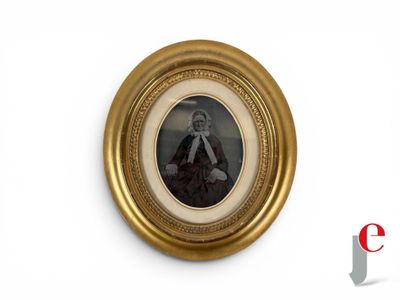 a picture of a woman in a gold frame on the wall