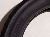 a tire on the side of a white wall