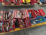 many boxes of tools sitting on a pallet in a warehouse