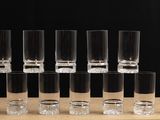 several shot glasses are lined up in a row on a table
