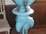 a large blue vase sitting on a pedestal in a room
