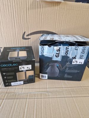 two boxes of headphones sitting on a cardboard box