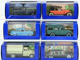 six toy cars are in a blue box on a white surface