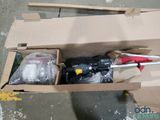 a cardboard box with tools inside of it on the floor