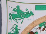 a green and white scarf with a picture of a man riding a horse