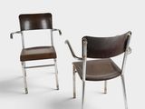 pair of chrome and leather chairs with armrests and backrests