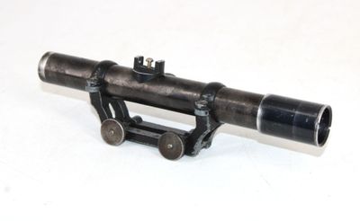 a small telescope that is sitting on a white surface