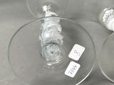 two empty wine glasses sitting next to each other on a table