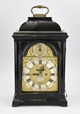 a black and gold clock with roman numerals on it