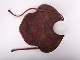 an old brown leather purse with a leather cord around it