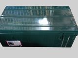 an image of a green metal box with a lid and a sticker on it
