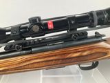 a close up of a rifle with a scope on top of it