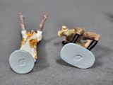 two figurines of a man riding a horse and a dog