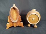 two wooden clocks sitting next to each other on a table