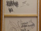 two drawings of a cat and a bird are on a wall