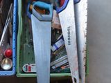 many tools in a box that are sitting on the floor