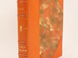 a book with an orange cover sitting on top of a white surface