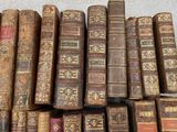 many old books stacked on top of each other