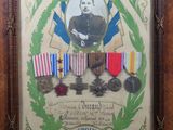 an old picture of a framed picture of a man with medals
