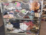 a metal cart with many items in it in a warehouse