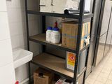 a shelf with boxes and a fire extinguisor in a kitchen