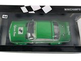 the green toy car is in the box on the white background