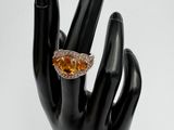 yellow sapphire and diamond ring on a black mannequin hand