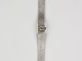 a close up of a watch on a white surface with a white background