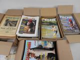 several magazines are in a cardboard box on a white surface