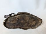 an antique bronze figurine of a fish on a white background