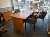 an image of a conference room with a desk and chairs