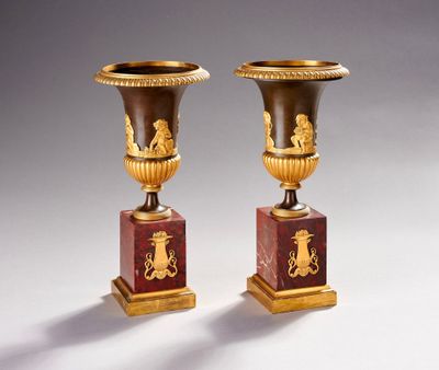 pair of antique vases with gold and red designs on marble bases