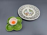 two plates and a bowl sitting on a table