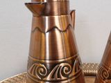 two metal salt and pepper shakers on a tray
