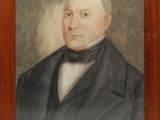 portrait of a man in a suit and bow tie in a wooden frame