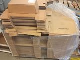 a large pile of boxes sitting on a pallet in a warehouse