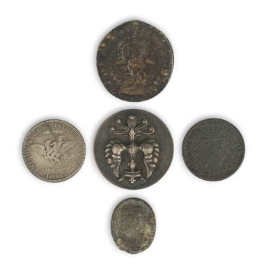 six different coins are arranged in a circle on a white surface