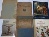 several books are sitting on a table with a white table cloth