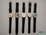 four different types of watches are lined up on a table