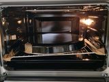 an open oven with a microwave inside of it
