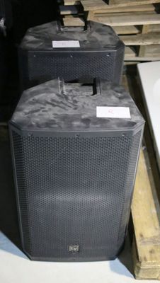 two speakers sitting next to each other on a pallet