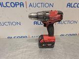 a red cordless drill is sitting on top of a table