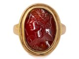 a close up of a gold ring with a red stone in the center