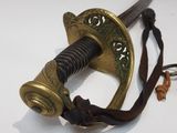 a close up of a sword on a white surface