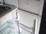 a white refrigerator that is open in the kitchen