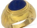 an image of a gold ring with a lapis stone in the center