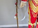 a statue of a man dressed in a red and gold outfit