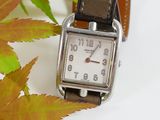 a watch that is sitting on top of a leaf