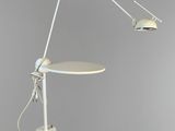 an image of a white table with a lamp on top of it